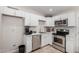 Modern kitchen with white cabinets and stainless steel appliances at 3646 N 69Th Ave # 60, Phoenix, AZ 85033