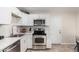 Modern kitchen with white cabinets and stainless steel appliances at 3646 N 69Th Ave # 60, Phoenix, AZ 85033