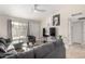 Open living room with sectional sofa, TV, and access to other rooms at 3646 N 69Th Ave # 60, Phoenix, AZ 85033