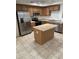 Spacious kitchen with island, stainless steel appliances, and tile flooring at 2402 E 5Th St # 1429, Tempe, AZ 85288