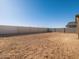Empty lot with block wall in new home community at 36853 W La Paz St, Maricopa, AZ 85138