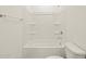 Clean bathroom with shower/tub combo and shelving at 36853 W La Paz St, Maricopa, AZ 85138