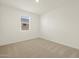Simple bedroom with carpeted floor and window at 36853 W La Paz St, Maricopa, AZ 85138