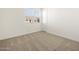 Spacious bedroom with neutral carpeting and a window with blinds at 36853 W La Paz St, Maricopa, AZ 85138