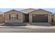 Single-story home with a two-car garage and desert landscaping at 36853 W La Paz St, Maricopa, AZ 85138