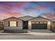 Single-story home with a two-car garage and desert landscaping at 36853 W La Paz St, Maricopa, AZ 85138