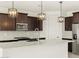 Modern kitchen with dark cabinetry and quartz countertops at 36853 W La Paz St, Maricopa, AZ 85138