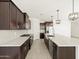 Modern kitchen features granite countertops and dark wood cabinetry at 36853 W La Paz St, Maricopa, AZ 85138