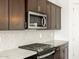 Gas range with stainless steel microwave above in the kitchen at 36853 W La Paz St, Maricopa, AZ 85138