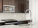 Close-up of kitchen sink and faucet with hexagon tile backsplash at 36853 W La Paz St, Maricopa, AZ 85138