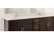 Double vanity with dark brown cabinets at 36853 W La Paz St, Maricopa, AZ 85138