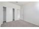 Bright, carpeted bedroom with a closet, and a view into the ensuite bathroom at 38125 W Excussare Way, Maricopa, AZ 85138