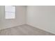 Bright bedroom with a window, carpeted floors, and light colored walls at 38125 W Excussare Way, Maricopa, AZ 85138