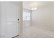 Bright entryway with a white front door, tile flooring, and a view into the adjacent room at 38125 W Excussare Way, Maricopa, AZ 85138