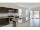 Stylish kitchen with stainless steel appliances, granite countertops, and a center island with a sink at 38125 W Excussare Way, Maricopa, AZ 85138