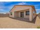 View of the covered patio in the low-maintenance backyard with gravel ground cover at 18156 W Cielo Grande Ave, Surprise, AZ 85387