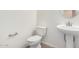 Clean and simple half bathroom with a pedestal sink, modern fixtures, and a convenient location at 18156 W Cielo Grande Ave, Surprise, AZ 85387