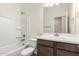 Bathroom showcasing vanity, toilet and shower-tub combo for ultimate convenience at 18156 W Cielo Grande Ave, Surprise, AZ 85387