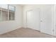 This is a cozy bedroom with neutral carpet and a closet with sliding doors at 18156 W Cielo Grande Ave, Surprise, AZ 85387