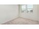Cozy bedroom with neutral carpet and window bringing in natural light at 18156 W Cielo Grande Ave, Surprise, AZ 85387