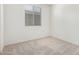 Inviting bedroom with neutral carpet and a window bringing in natural light at 18156 W Cielo Grande Ave, Surprise, AZ 85387