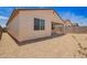 Rear exterior view of the home showcasing backyard and covered patio at 18156 W Cielo Grande Ave, Surprise, AZ 85387