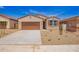 Charming single-story home showcasing a desert landscape, neutral colors, and a two-car garage at 18156 W Cielo Grande Ave, Surprise, AZ 85387