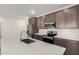 Stylish kitchen with a central island, stainless steel appliances, and ample storage in espresso cabinetry at 18156 W Cielo Grande Ave, Surprise, AZ 85387