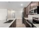 Well-designed kitchen with stainless steel appliances, white quartz countertops, and modern fixtures at 18156 W Cielo Grande Ave, Surprise, AZ 85387