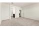 Spacious primary bedroom with neutral carpet and ensuite bathroom access, creating a private retreat at 18156 W Cielo Grande Ave, Surprise, AZ 85387