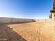 Large backyard with block wall and sandy ground at 36893 W La Paz St, Maricopa, AZ 85138