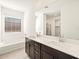 Bathroom with double vanity and large mirror at 36893 W La Paz St, Maricopa, AZ 85138
