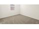 Simple bedroom with neutral carpeting and a window at 36893 W La Paz St, Maricopa, AZ 85138