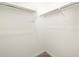 White closet with double hanging rods and neutral carpeting at 36893 W La Paz St, Maricopa, AZ 85138