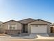 New construction home with a two-car garage and neutral exterior at 36893 W La Paz St, Maricopa, AZ 85138