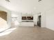 Eat-in kitchen boasts dark cabinetry, granite countertops and stainless steel appliances at 36893 W La Paz St, Maricopa, AZ 85138