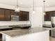 Modern kitchen with stainless steel appliances and granite countertops at 36893 W La Paz St, Maricopa, AZ 85138