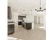 Modern kitchen with an island, stainless steel appliances, and dark cabinets at 36893 W La Paz St, Maricopa, AZ 85138