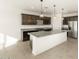 Modern kitchen with island and stainless steel appliances at 36893 W La Paz St, Maricopa, AZ 85138