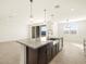 Open concept kitchen with island and granite countertops at 36893 W La Paz St, Maricopa, AZ 85138