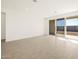 Open living area with tile floors and sliding glass doors opening to a patio at 36893 W La Paz St, Maricopa, AZ 85138