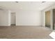 Spacious living room featuring tile floors and access to a patio at 36893 W La Paz St, Maricopa, AZ 85138