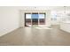 Living room with tile floors, sliding glass doors, and kitchen views at 36893 W La Paz St, Maricopa, AZ 85138