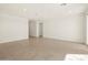 Bright living room with tile floors and sliding glass doors leading to the backyard at 36893 W La Paz St, Maricopa, AZ 85138