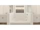 Elegant bathroom with a free-standing tub and double vanities at 36894 W La Paz St, Maricopa, AZ 85138
