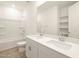 Bathroom with double vanity, bathtub, and built-in shelving at 36894 W La Paz St, Maricopa, AZ 85138