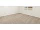 Bright bedroom with neutral carpeting and window at 36894 W La Paz St, Maricopa, AZ 85138