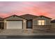 Single story home with a two-car garage, neutral color scheme and landscaping at 36894 W La Paz St, Maricopa, AZ 85138