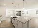 Open concept kitchen with large island, granite counters and view to Gathering room at 36894 W La Paz St, Maricopa, AZ 85138