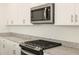Modern kitchen features stainless steel appliances and granite countertops at 36894 W La Paz St, Maricopa, AZ 85138
